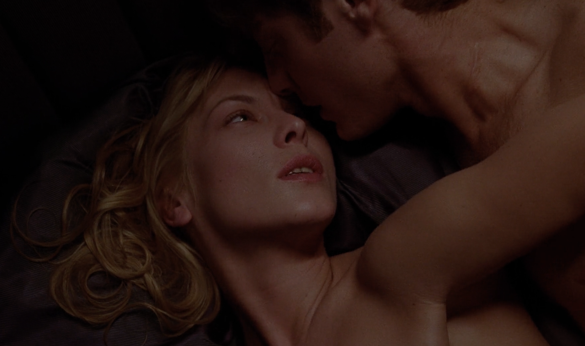 Catherine and James having sex. She's looking back at him.