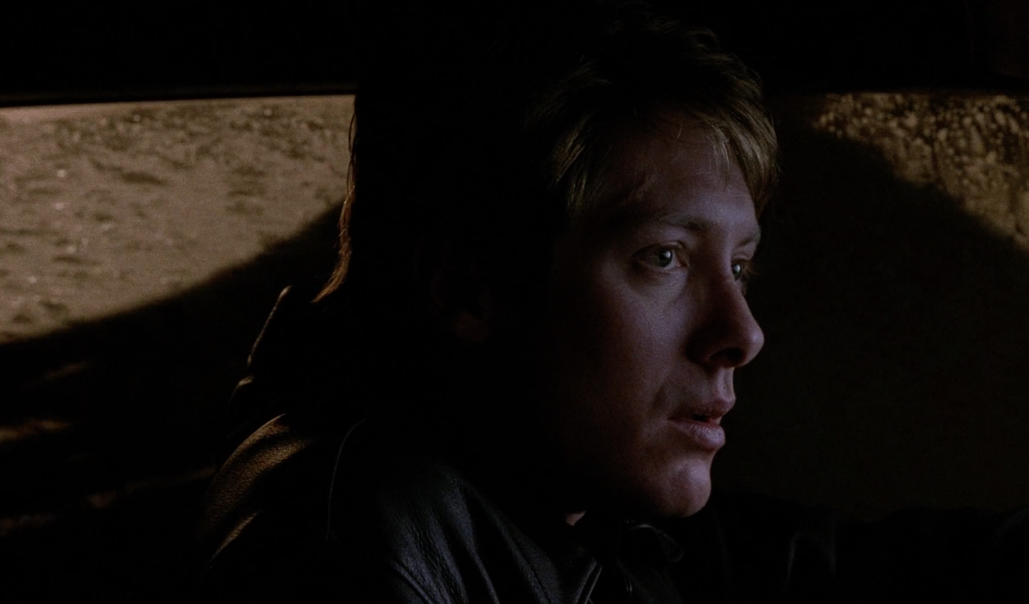 James watches Vaughan and Catherine in the rearview mirror. 