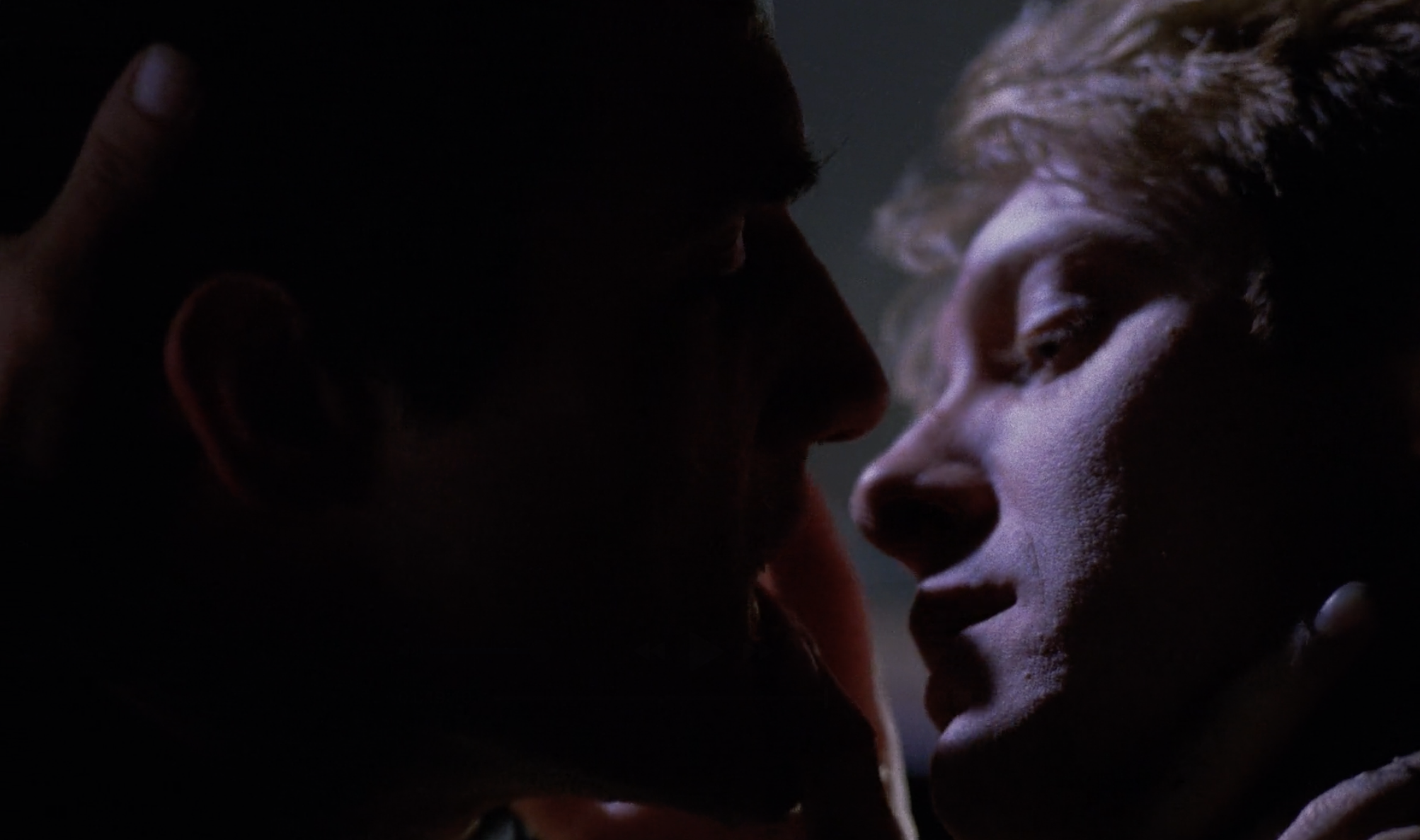 James leans in to kiss Vaughan (Elias Koteas)